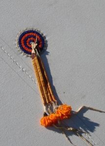 This beaded rosette, attached to a friend's tipi, is a representation of the Cheyenne Women's Sewing Society group.  "If you can make the rosettes'. beaded back panel, pillows, tipis, and other accoutrements you then are a member of the society," says Linda.